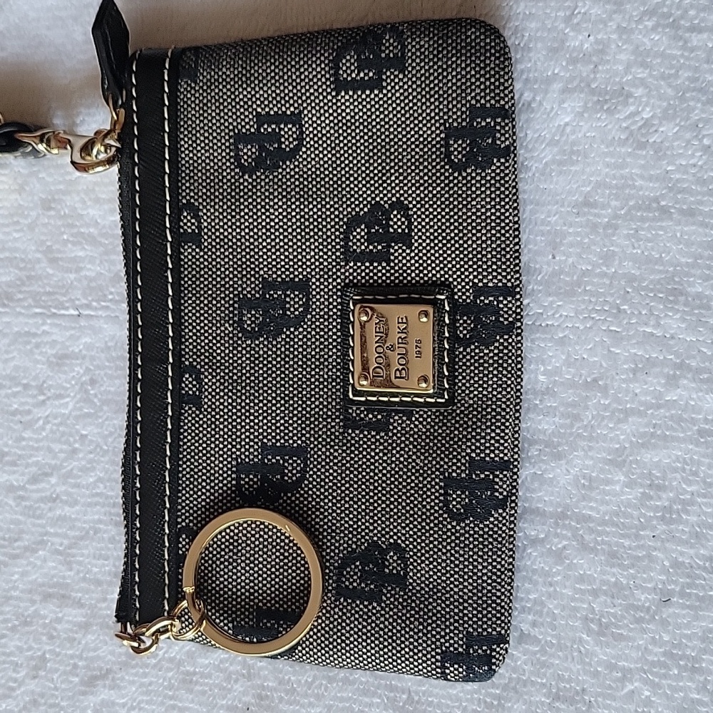 D&B wristlet trimmed in leather. Monogram pattern. Used but good conditio
